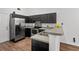 Modern kitchen featuring stainless steel appliances, gray countertops, and dark cabinetry for a sleek design at 5024 Blair Rd, Summerville, SC 29483