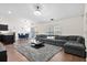 Spacious living room featuring a gray sectional, plush rug, and modern decor at 5024 Blair Rd, Summerville, SC 29483