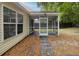 View of the screened-in porch and backyard, perfect for enjoying the outdoors at 5024 Blair Rd, Summerville, SC 29483