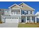 Beautiful two-story home with light gray siding, white trim, and a two-car garage at 513 Verdi Dr, Summerville, SC 29486