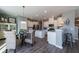 Open-concept kitchen and dining area with stainless steel appliances and a breakfast bar at 513 Verdi Dr, Summerville, SC 29486