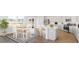 Open-concept kitchen and dining area features white cabinets, an island with seating, and stainless appliances at 519 Verdi Dr, Summerville, SC 29486