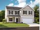Charming two-story home with beige siding, a well-manicured lawn and a white garage door at 614 Cottage Landing Dr, Summerville, SC 29485
