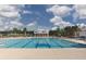 Large community pool with clear blue water surrounded by landscaping and palm trees at 614 Cottage Landing Dr, Summerville, SC 29485