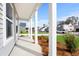 Relaxing covered porch offering a view of the neighborhood with freshly cut grass and manicured lawn at 657 Cottage Landing Dr, Summerville, SC 29485
