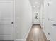 Hallway showcasing modern lighting, neutral walls, and durable flooring with a view to the outdoors at 657 Cottage Landing Dr, Summerville, SC 29485