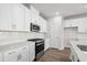 Bright kitchen with stainless appliances, gas range, stylish backsplash, and white cabinetry at 657 Cottage Landing Dr, Summerville, SC 29485
