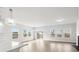 Bright open-concept living area with large windows, durable flooring, and modern chandelier at 657 Cottage Landing Dr, Summerville, SC 29485