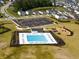Community pool with lounge chairs, playground, parking lot, and surrounding neighborhood with a pond at 707 Redbud Ln, Summerville, SC 29486