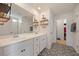Modern bathroom with double sink vanity and decorative tile flooring at 707 Redbud Ln, Summerville, SC 29486