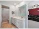 Well-lit bathroom featuring a large mirror and white cabinets at 707 Redbud Ln, Summerville, SC 29486
