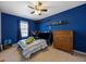 Charming bedroom with blue walls, shelf decor, and a light-colored carpet at 707 Redbud Ln, Summerville, SC 29486