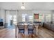 Dining area with table and chairs, large windows, and a sliding door leading to the backyard at 707 Redbud Ln, Summerville, SC 29486