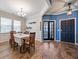 Charming dining room with wood floors, stylish lighting, and access to additional living spaces at 707 Redbud Ln, Summerville, SC 29486