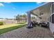 Enjoy a covered patio with brick flooring, comfortable seating, and a view of the backyard at 707 Redbud Ln, Summerville, SC 29486