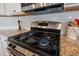 Close-up of the stainless steel gas range at 707 Redbud Ln, Summerville, SC 29486