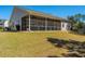 Large backyard with lawn and a screened in patio area on the home at 718 Kilarney Rd, Summerville, SC 29483