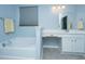 Bright bathroom featuring a large mirror, double sink vanity, bathtub, and tile flooring at 718 Kilarney Rd, Summerville, SC 29483