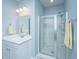 Bright bathroom featuring a large mirror, sink vanity, glass-enclosed shower, and tile flooring at 718 Kilarney Rd, Summerville, SC 29483