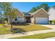 Charming home with a well-manicured lawn, a red front door and a two car garage at 718 Kilarney Rd, Summerville, SC 29483