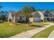 View of the home's exterior, including well-maintained landscaping and an attached two car garage at 718 Kilarney Rd, Summerville, SC 29483