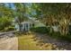 Charming single-story home with a neatly landscaped yard, mature trees, and a welcoming front porch at 718 Kilarney Rd, Summerville, SC 29483