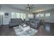 Open-concept living room with plush seating, hardwood floors and a large ceiling fan at 718 Kilarney Rd, Summerville, SC 29483