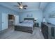 Comfortable main bedroom with blue walls, carpet, tray ceiling, ceiling fan, and a dark wood bed with floral bedding at 718 Kilarney Rd, Summerville, SC 29483