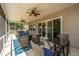Comfortable screened in patio with an outdoor ceiling fan and decorative area rug at 718 Kilarney Rd, Summerville, SC 29483
