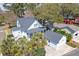 Aerial view of a home with a screened porch, fenced yard, garage and mature trees at 724 Hibbens Grant Blvd, Mount Pleasant, SC 29464