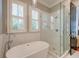 Luxurious bathroom with a freestanding tub and a glass-enclosed shower, offering a spa-like experience at 724 Hibbens Grant Blvd, Mount Pleasant, SC 29464