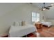 Bright bedroom featuring two twin beds with wood flooring, a ceiling fan, and shuttered windows at 724 Hibbens Grant Blvd, Mount Pleasant, SC 29464