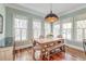 Light-filled dining area featuring hardwood floors, large windows, and stylish furnishings, perfect for Gathering meals at 724 Hibbens Grant Blvd, Mount Pleasant, SC 29464