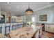 Open-concept dining room with breakfast bar access to kitchen, modern decor, and access to outdoor patio at 724 Hibbens Grant Blvd, Mount Pleasant, SC 29464