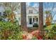 Inviting home exterior featuring a front porch, blossoming flowers, and mature trees at 724 Hibbens Grant Blvd, Mount Pleasant, SC 29464
