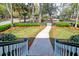 Inviting walkway leading to the home, framed by lush landscaping and an adorable fence for great curb appeal at 724 Hibbens Grant Blvd, Mount Pleasant, SC 29464