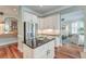 This is a bright kitchen featuring stainless refrigerator, granite countertop and seamless access to other rooms at 724 Hibbens Grant Blvd, Mount Pleasant, SC 29464