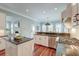 This is a kitchen featuring granite countertops, stainless appliances, and adjacent dining and living rooms at 724 Hibbens Grant Blvd, Mount Pleasant, SC 29464