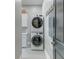 Well-lit laundry room with a stacked washer and dryer and white cabinets at 724 Hibbens Grant Blvd, Mount Pleasant, SC 29464