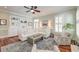 Open-concept living room featuring large windows, comfortable seating, and a stylish area rug at 724 Hibbens Grant Blvd, Mount Pleasant, SC 29464