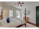 Bright main bedroom featuring a four-poster bed, a ceiling fan, and a private balcony at 724 Hibbens Grant Blvd, Mount Pleasant, SC 29464