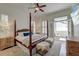 Elegant main bedroom with a four-poster bed, ample natural light, and access to a private balcony at 724 Hibbens Grant Blvd, Mount Pleasant, SC 29464
