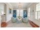 Sunlit office space featuring stylish light blue armchairs, white trim, and refinished wood floors at 724 Hibbens Grant Blvd, Mount Pleasant, SC 29464