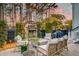 Charming outdoor patio featuring a fireplace, ample seating, and a built-in grill for entertaining at 724 Hibbens Grant Blvd, Mount Pleasant, SC 29464