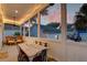 Inviting screened porch featuring a dining table, seating area, and views of the lush backyard at 724 Hibbens Grant Blvd, Mount Pleasant, SC 29464