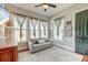Cozy sitting room with neutral walls, gray sofa, plush carpet, and an abundance of natural light filtering through shuttered windows at 724 Hibbens Grant Blvd, Mount Pleasant, SC 29464