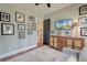 Sitting room with a television, wooden cabinet, wood flooring, neutral walls, and an assortment of framed artwork at 724 Hibbens Grant Blvd, Mount Pleasant, SC 29464
