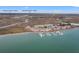 Aerial view displays 76 Mariners Cay's proximity to Charleston airport, Charleston peninsula, and surrounding marshland at 76 Mariners Cay Dr, Folly Beach, SC 29439