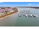 Aerial view of a marina featuring numerous boats and waterfront condominiums at 76 Mariners Cay Dr, Folly Beach, SC 29439