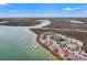 An aerial view shows 76 Mariners Cay with marina, waterway, marshland, and surrounding area at 76 Mariners Cay Dr, Folly Beach, SC 29439